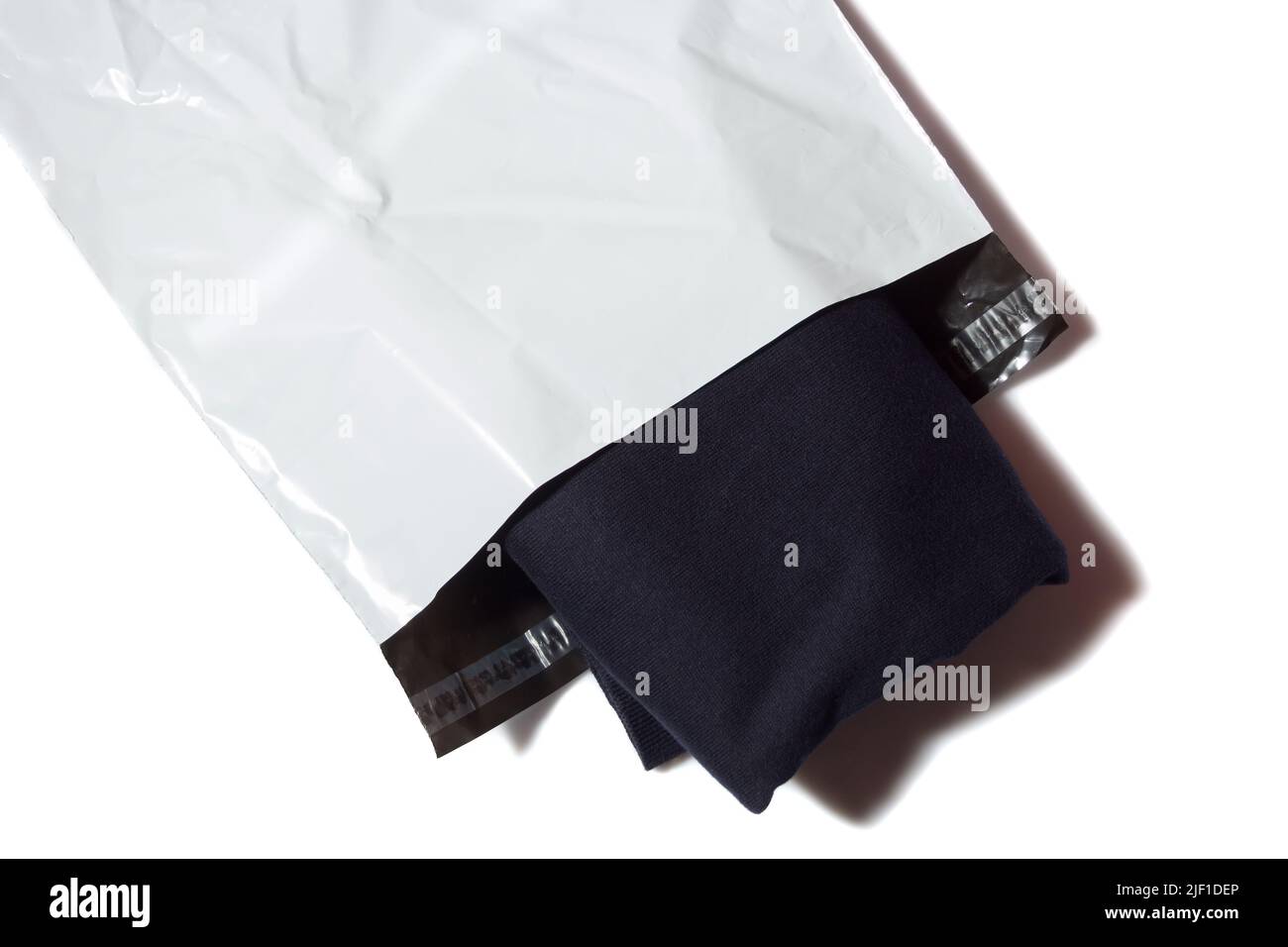 jumper in white mailing bag Stock Photo