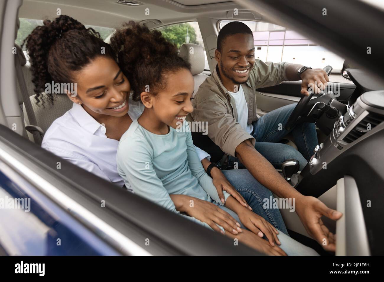 Cheerful African American Family Posing In Automobile Inside Stock Photo