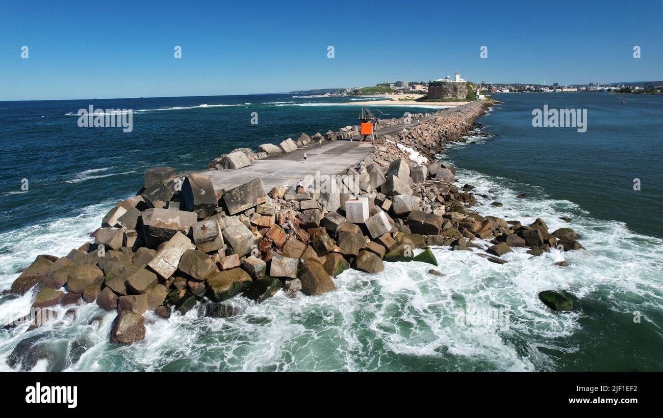A pier with stone wavebrakers captured from the sea Stock Photo