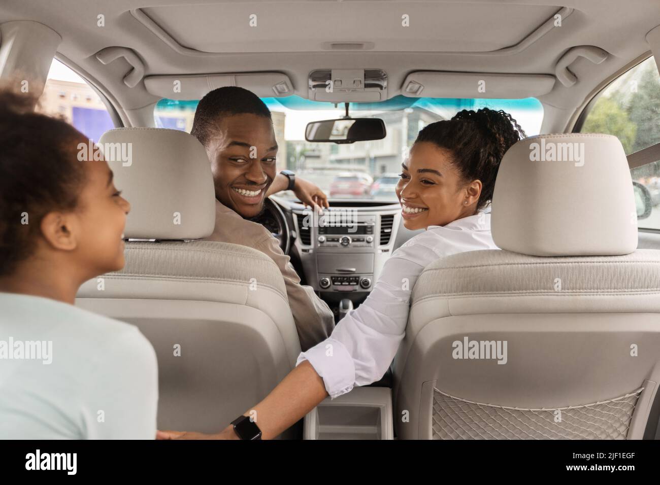 Back View Of African American Family Sitting In New Car Stock Photo