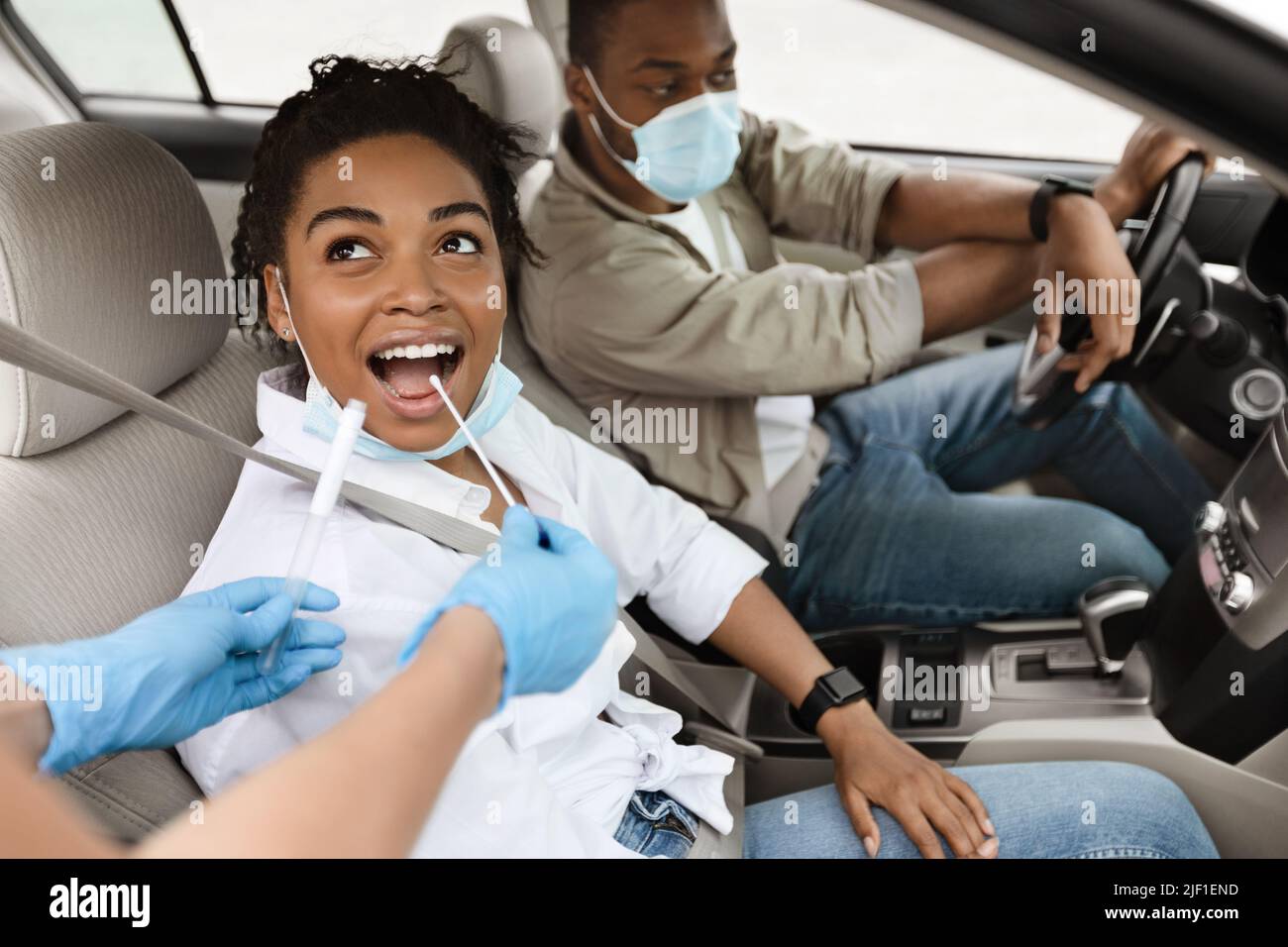 Black Woman Getting Tested For Covid-19 Sitting In Auto Stock Photo