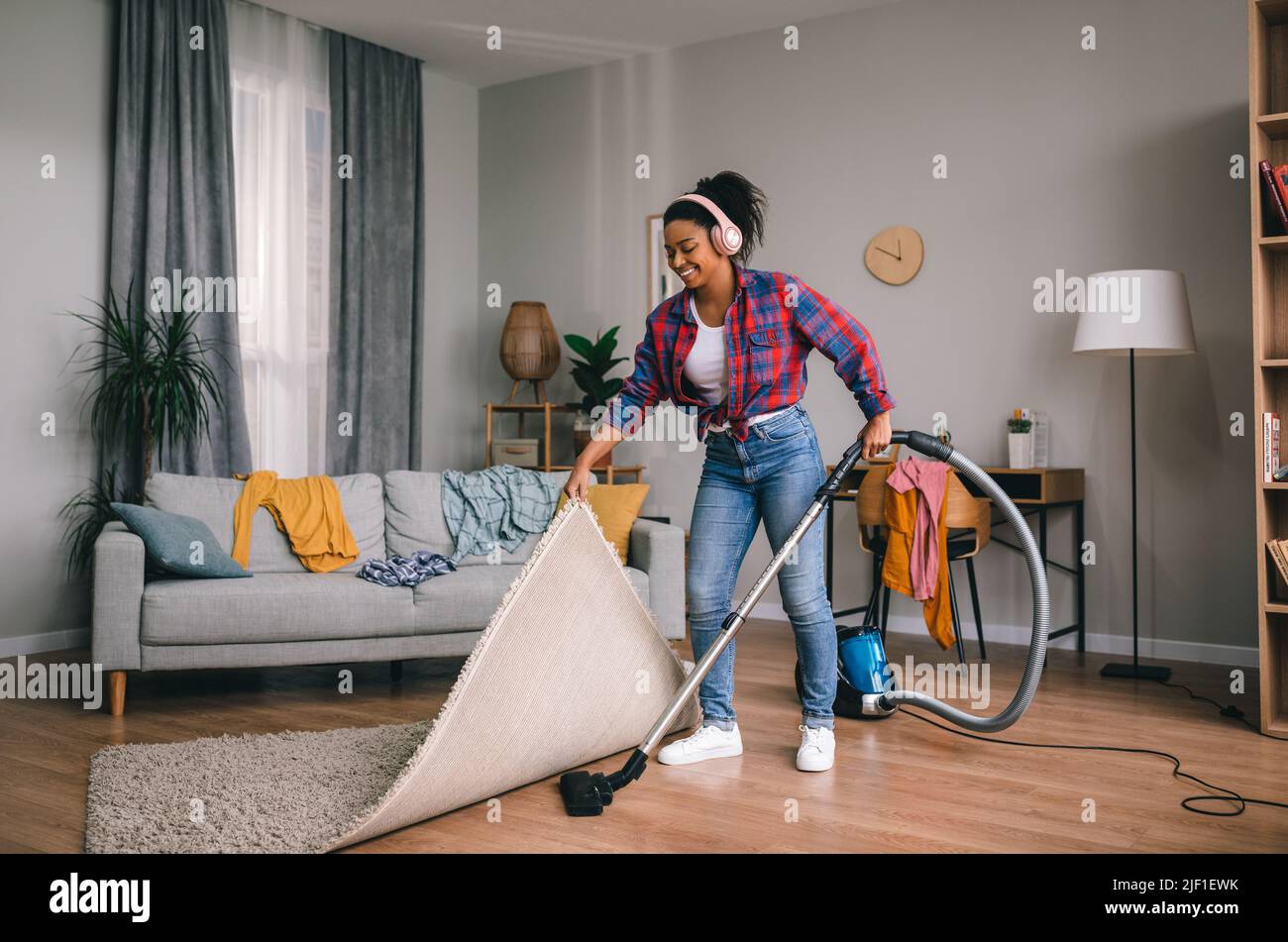 Woman vacuuming happy hi-res stock photography and images - Alamy