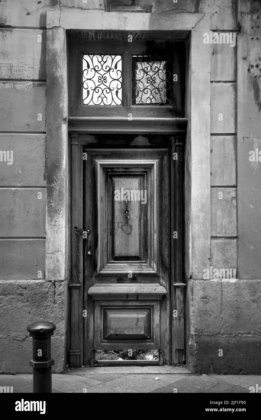 Old wooden door with wrought iron details in Alicante city, Spain Stock Photo