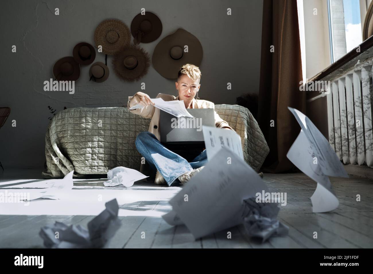 Job burnout, chronic workplace stress, exhaustion. Angry stressed out young woman working on laptop Stock Photo
