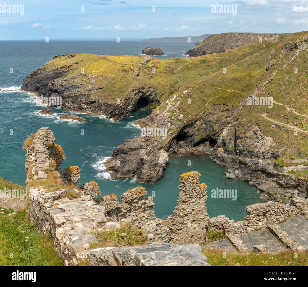 Tintagel Castle is a medieval fortification on top of the peninsula of Tintagel Island adjacent to the village of Tintagel in North Cornwall. Stock Photo