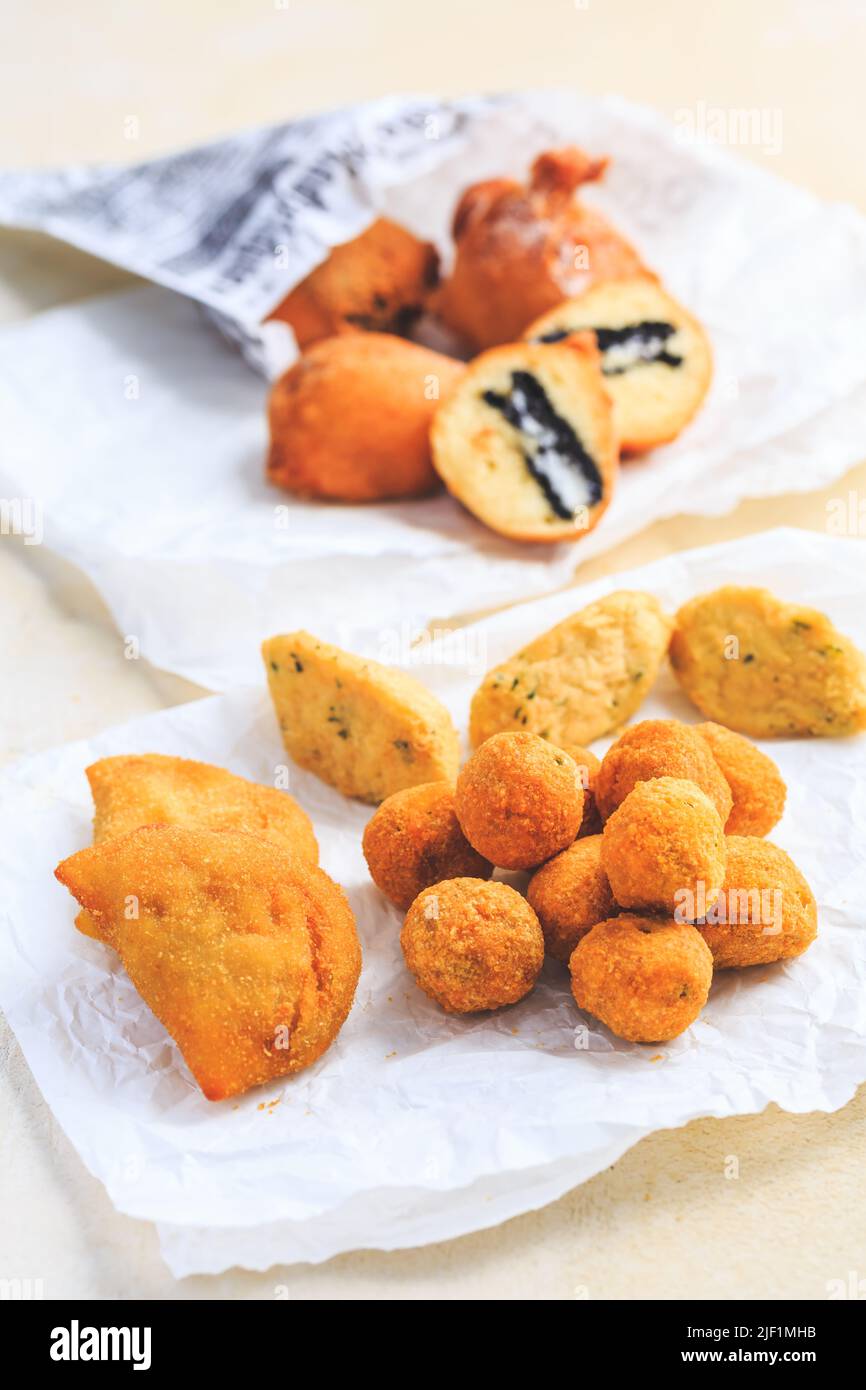 Finger food and street food - assortment of Arancini rice balls, fried curd balls, cod pies Stock Photo