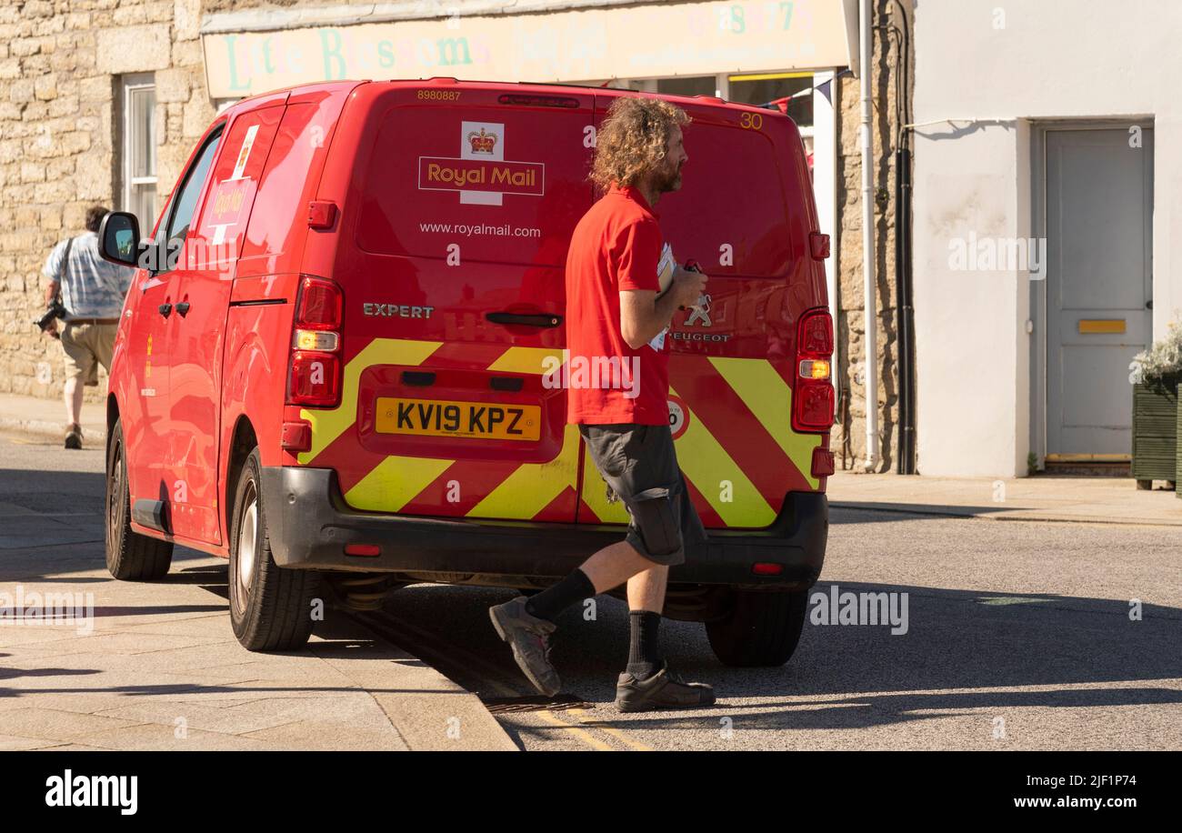 St Just, Cornwall, England, UK. 2022. Royal Mail red van and postman working in this famous Cornish town, UK. Stock Photo