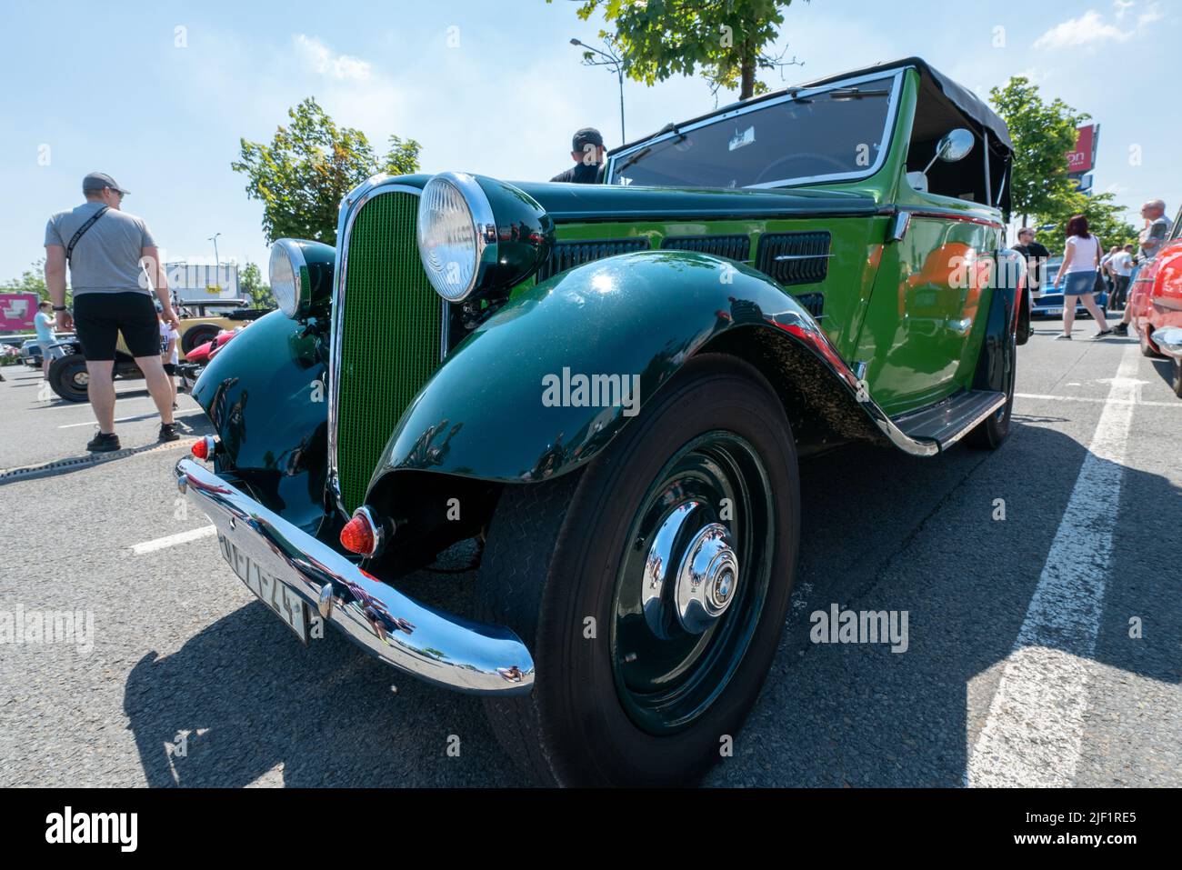 Ostrava, Czechia - 06.05.2022: Low angle frontal wide shot of very old green BMW veteran car. People admiring retro cars during veteran rallye event Stock Photo