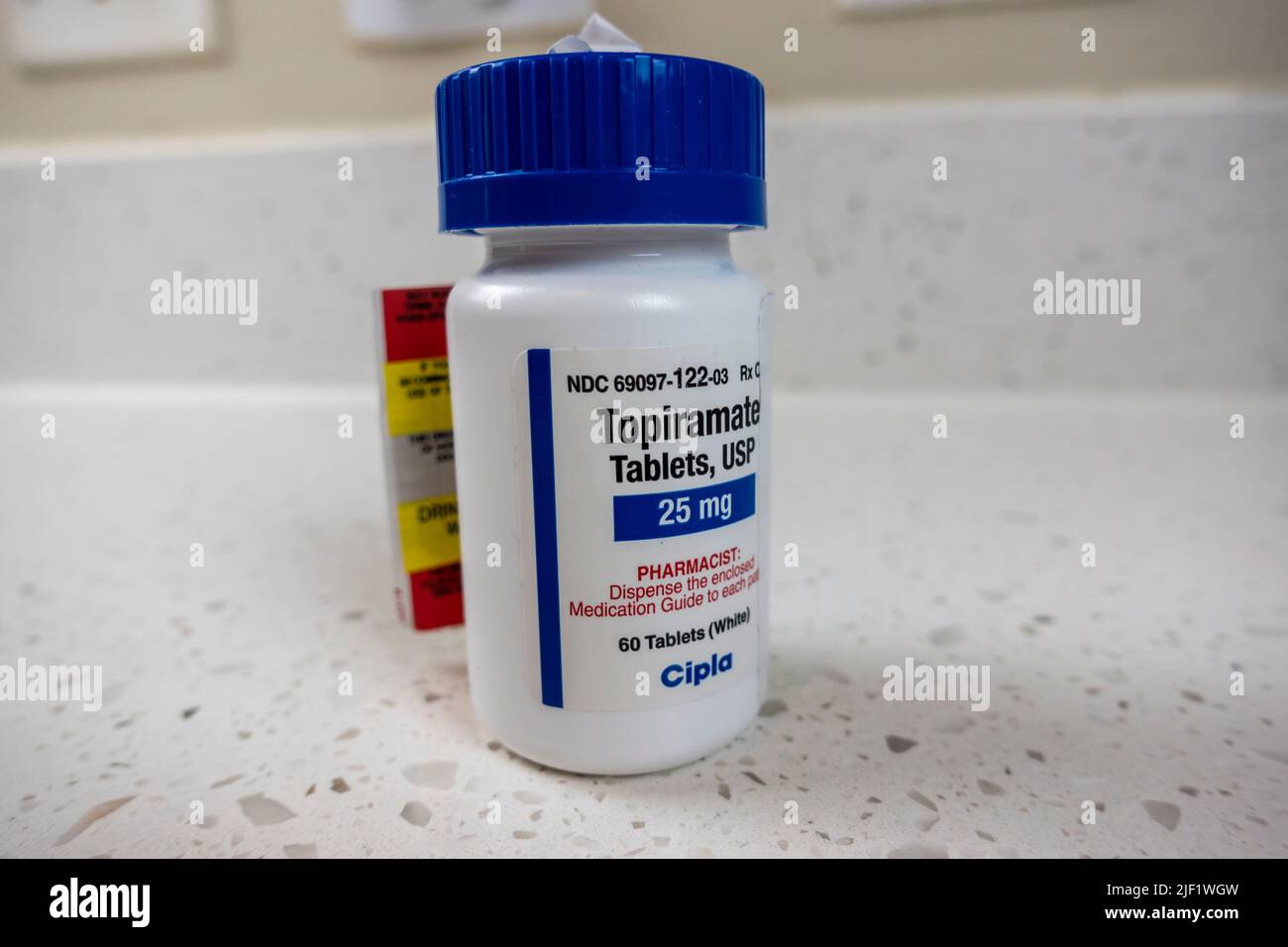 Seattle, WA USA - circa May 2022: Angled view of a bottle of Topiramate medication on a white counter top. Stock Photo
