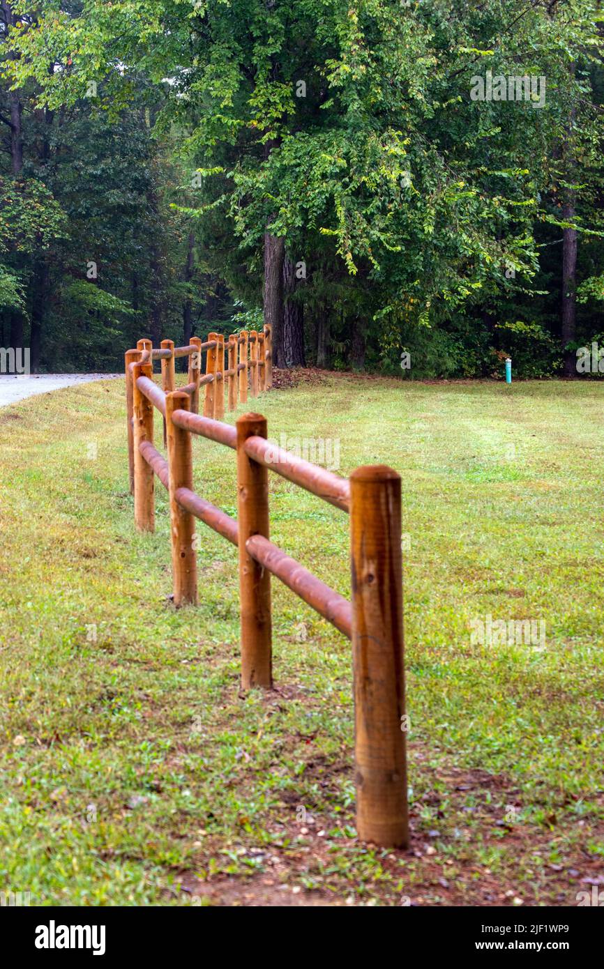 With vertical and horizontal rounded boards, this wooden rail fence ...