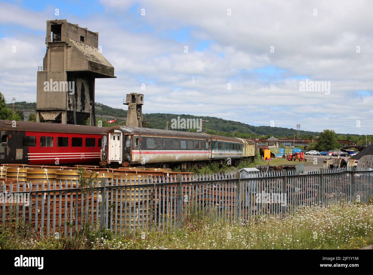 View into part of West Coast railways base at Carnforth showing old coaches and the coaling plant historic listed building, June 2022. Stock Photo