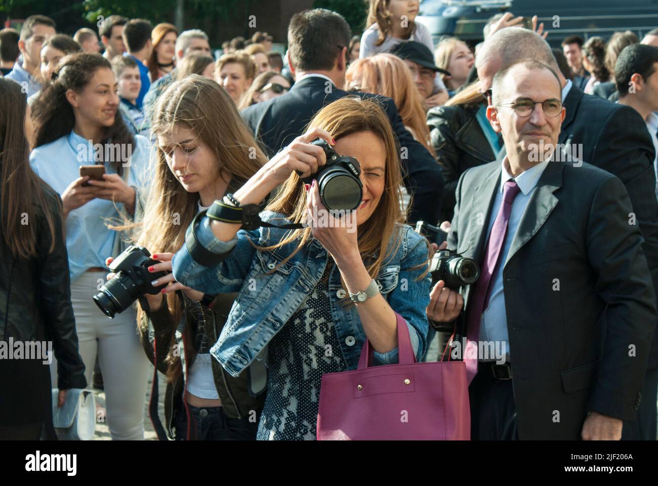 Female photographer in action. Stock Photo