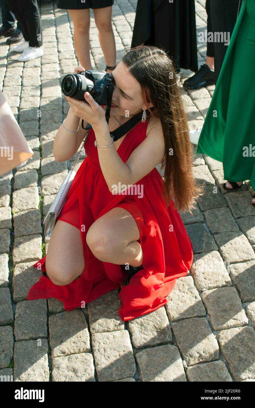 Female photographer in action. Stock Photo