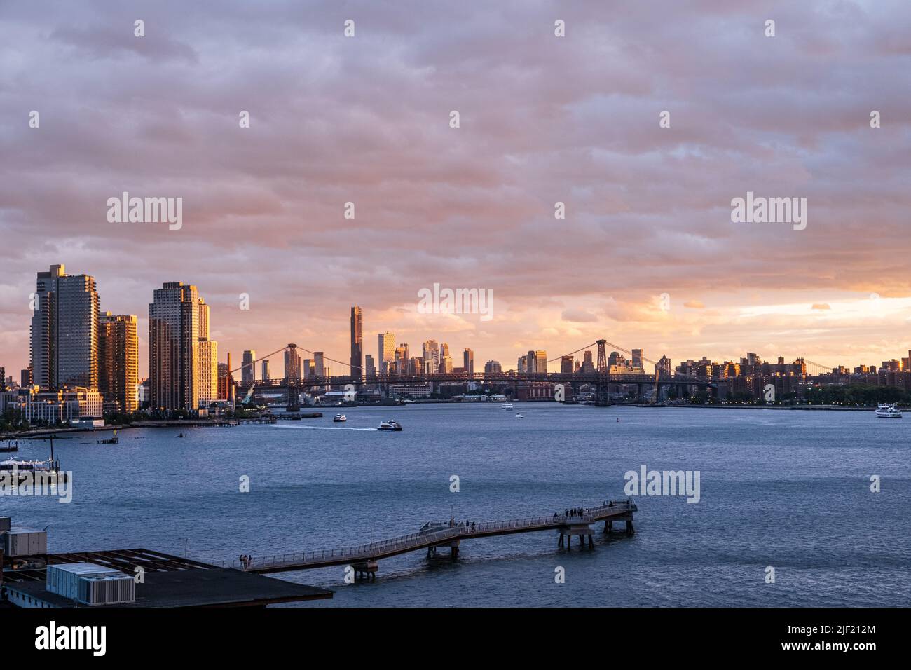 An evening sunset sky over the water with the New York skyline Stock ...