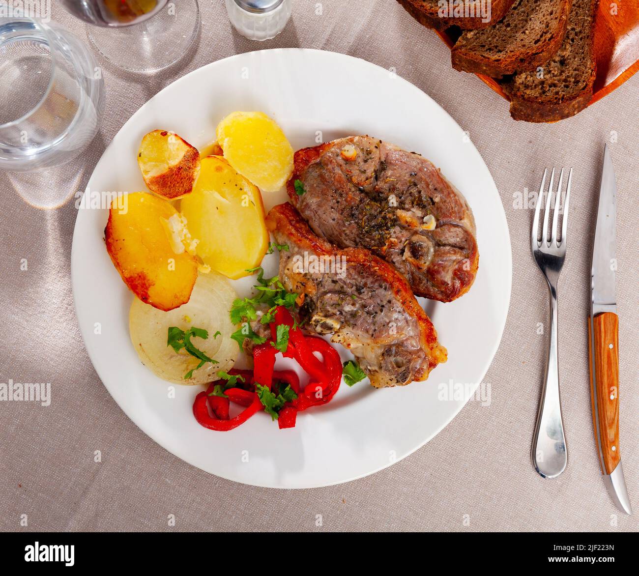 Lamb leg served with potatoes and pepper Stock Photo - Alamy