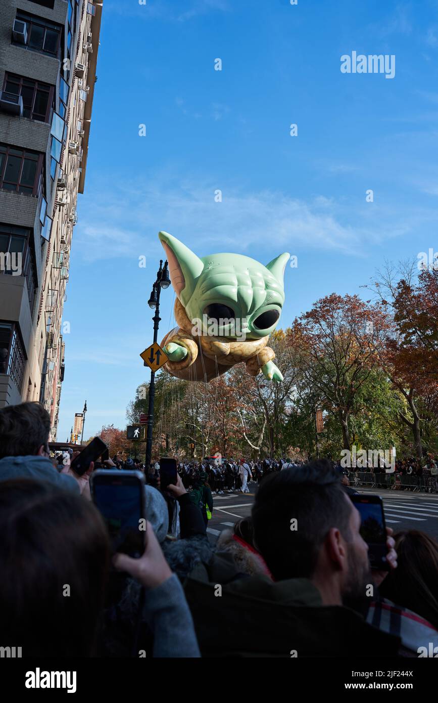 Manhattan, USA - 24. November 2021: Baby Yoda Balloon from the Mandalorian at Macy's Parade in NYC. Thanksgiving Parade with cute Baby Yoda Stock Photo