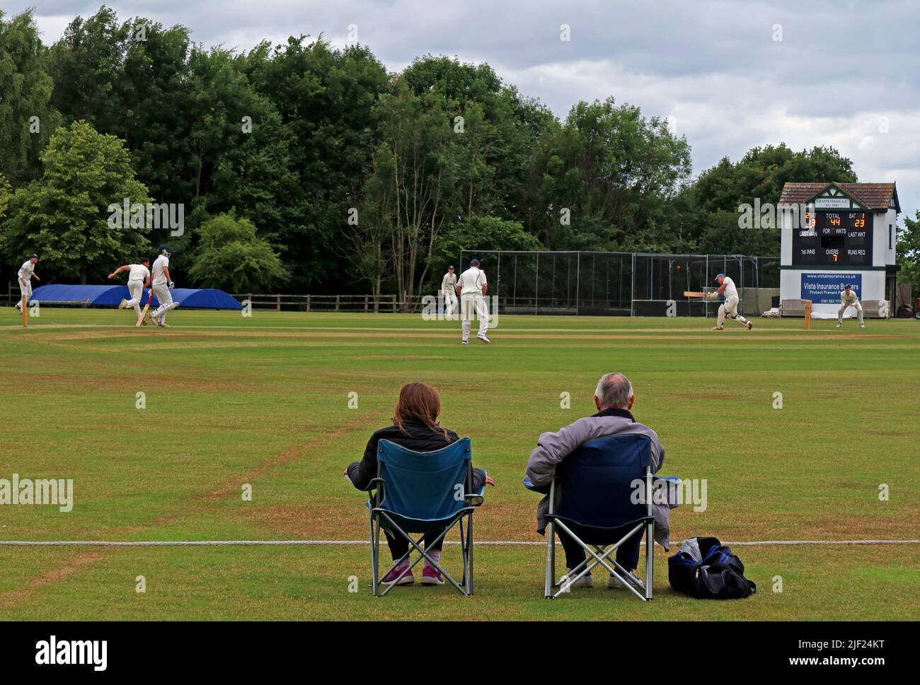 Two spectators watch Grappenhall Cricket Club - 3rd XI vs Ashley CC, Cheshire - 4th XI Cricket Club, Broad Lane, Grappenhall, Warrington, WA4 3ER Stock Photo