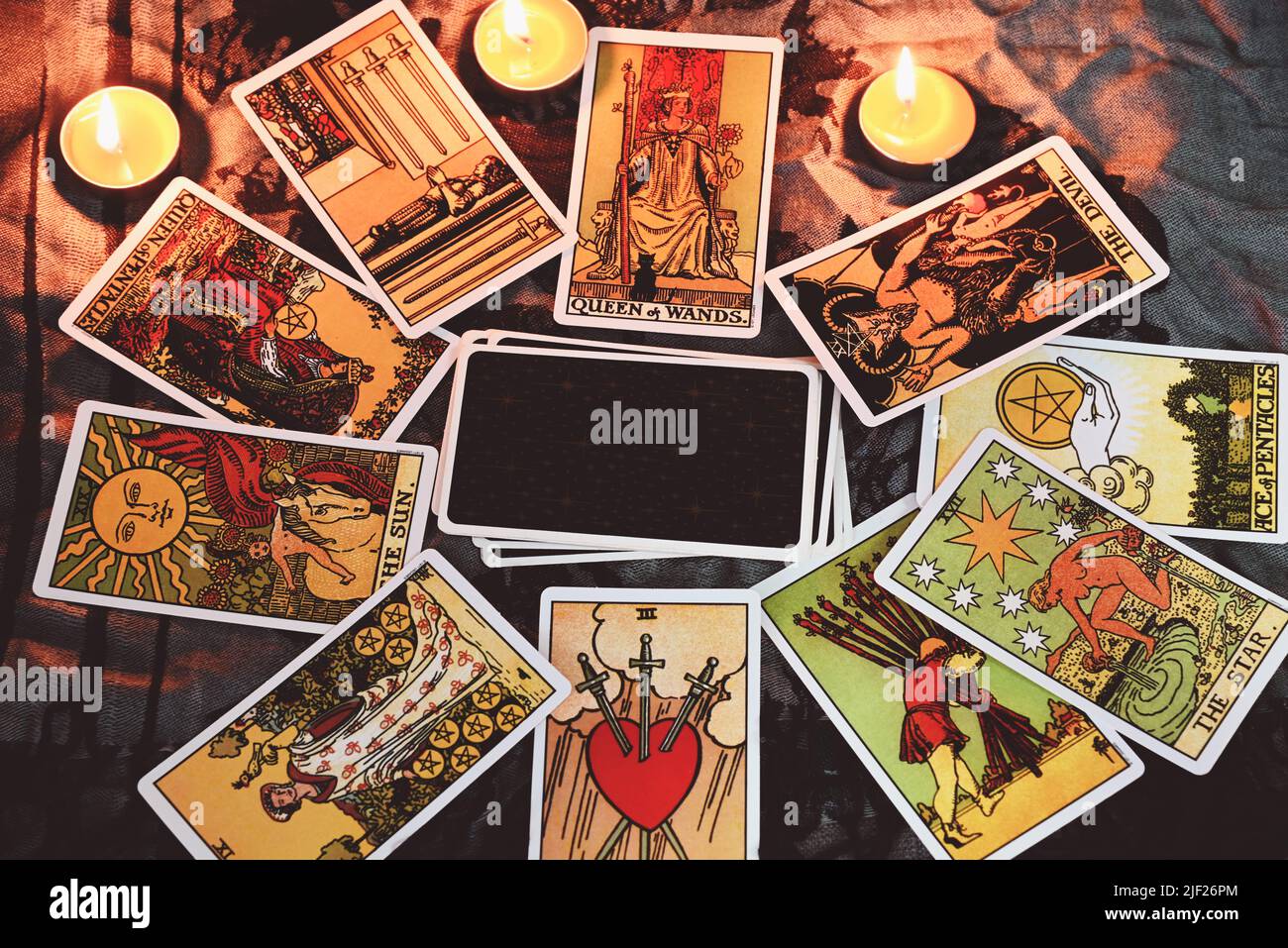 Tarot reading with tarot card background and candlelight on the table