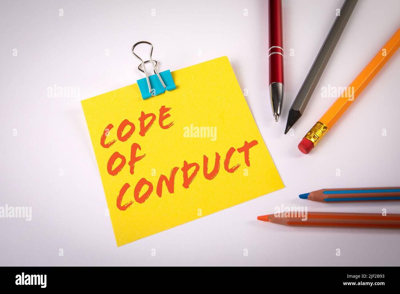 Code of Conduct. Sheet of paper with text and colored pencils on a ...