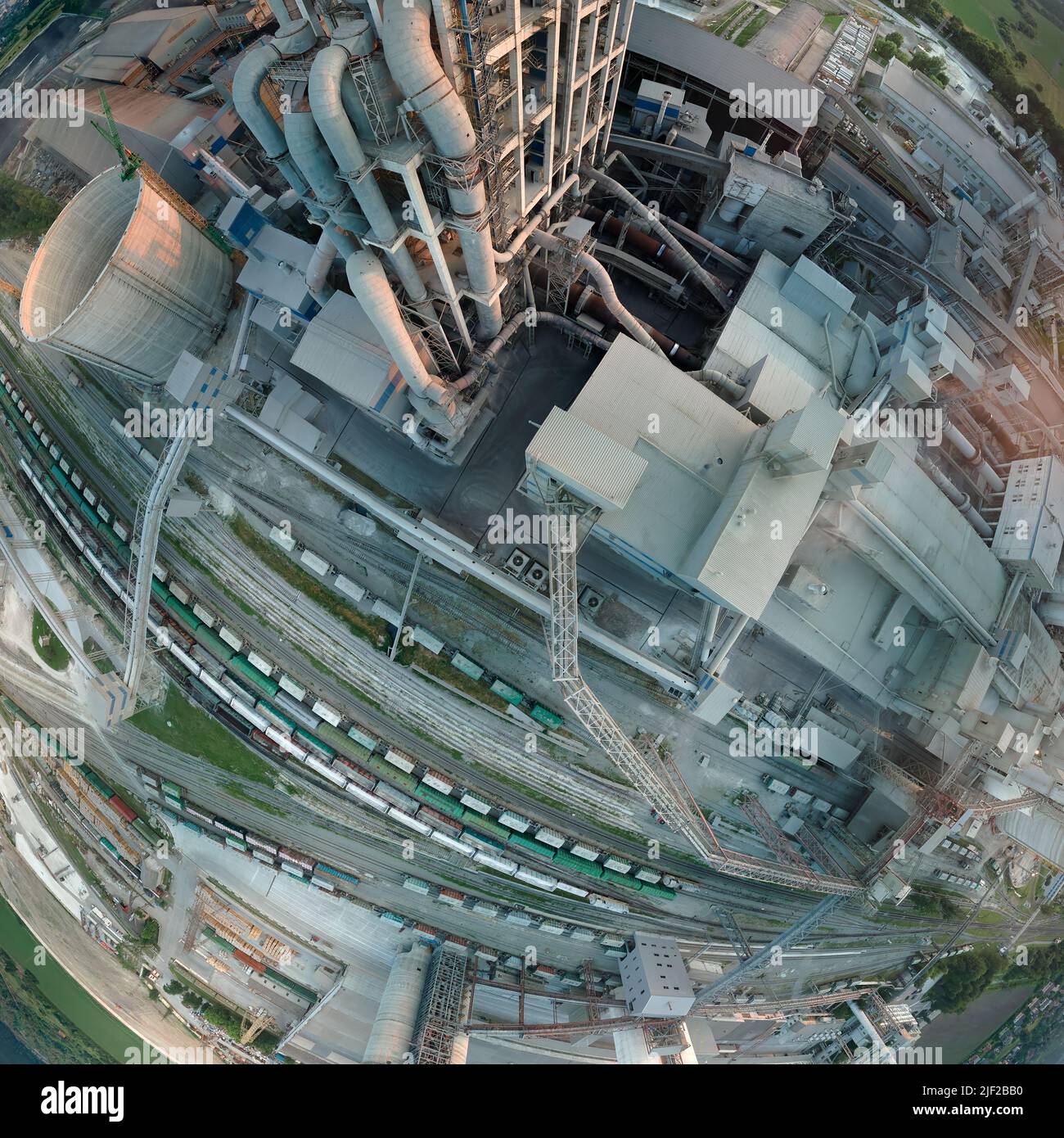 Cement plant with high factory structure and tower cranes at industrial ...