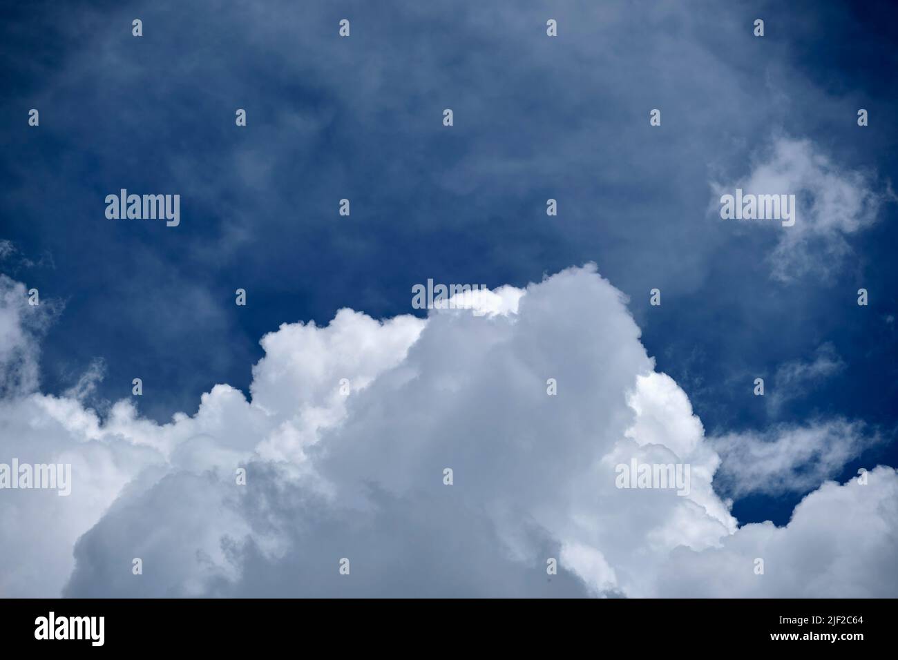White puffy cumulus clouds on summer blue sky Stock Photo - Alamy