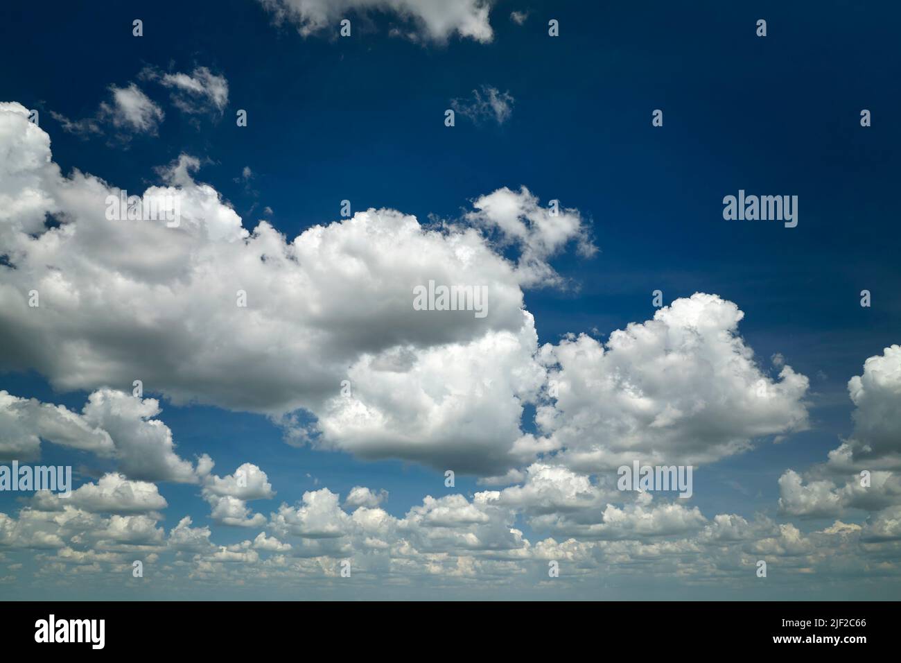 White puffy cumulus clouds on summer blue sky Stock Photo - Alamy