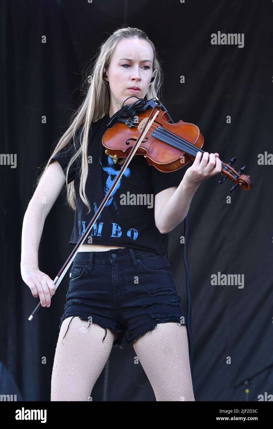 Fiddle player Bronwyn Keith-Hynes is shown performing on stage during a “live” concert appearance with Molly Tuttle and The Golden Highway at the Green River Festival. Stock Photo