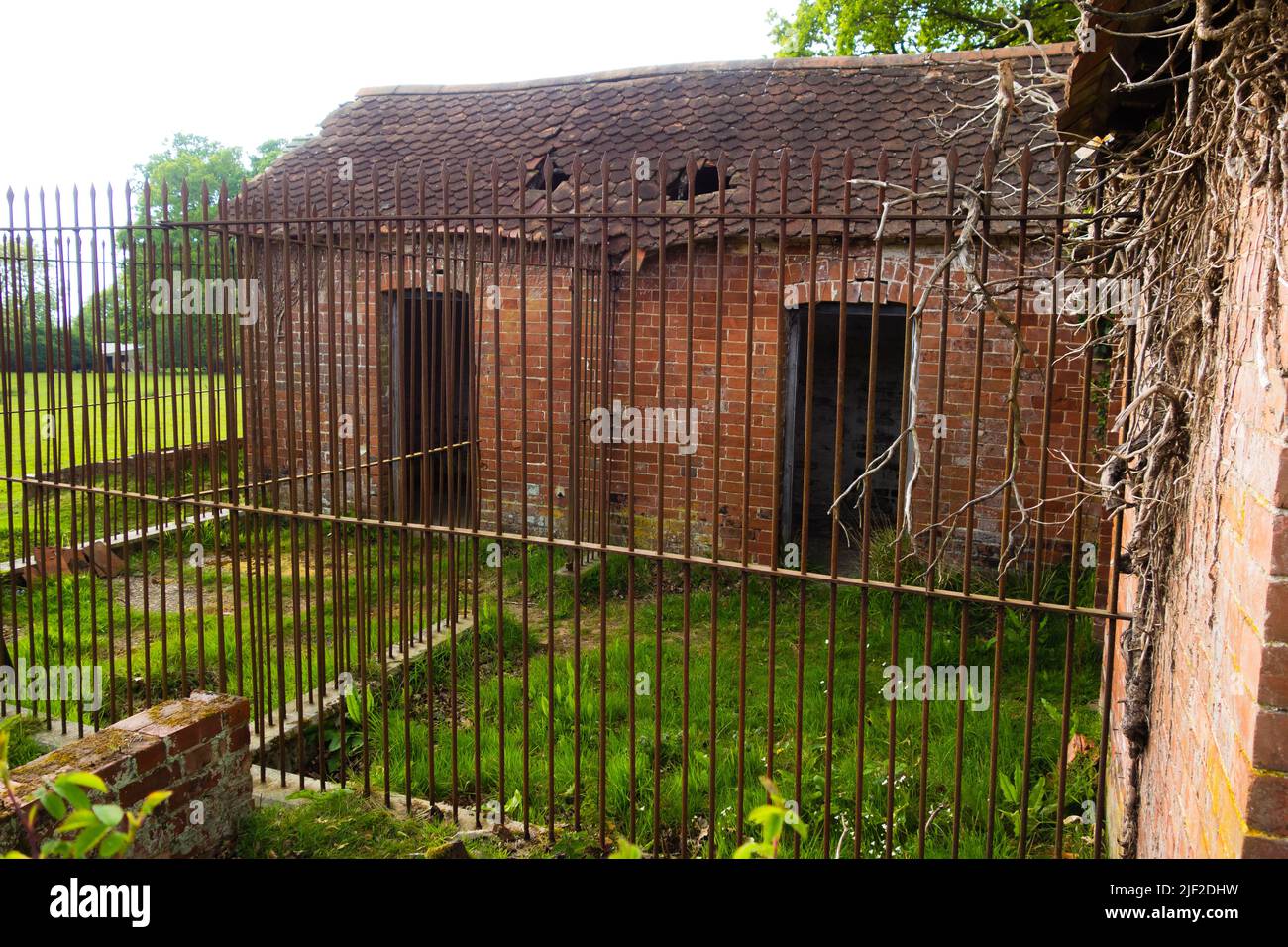 old brick built Victorian dog kennels and runs with iron fencing and