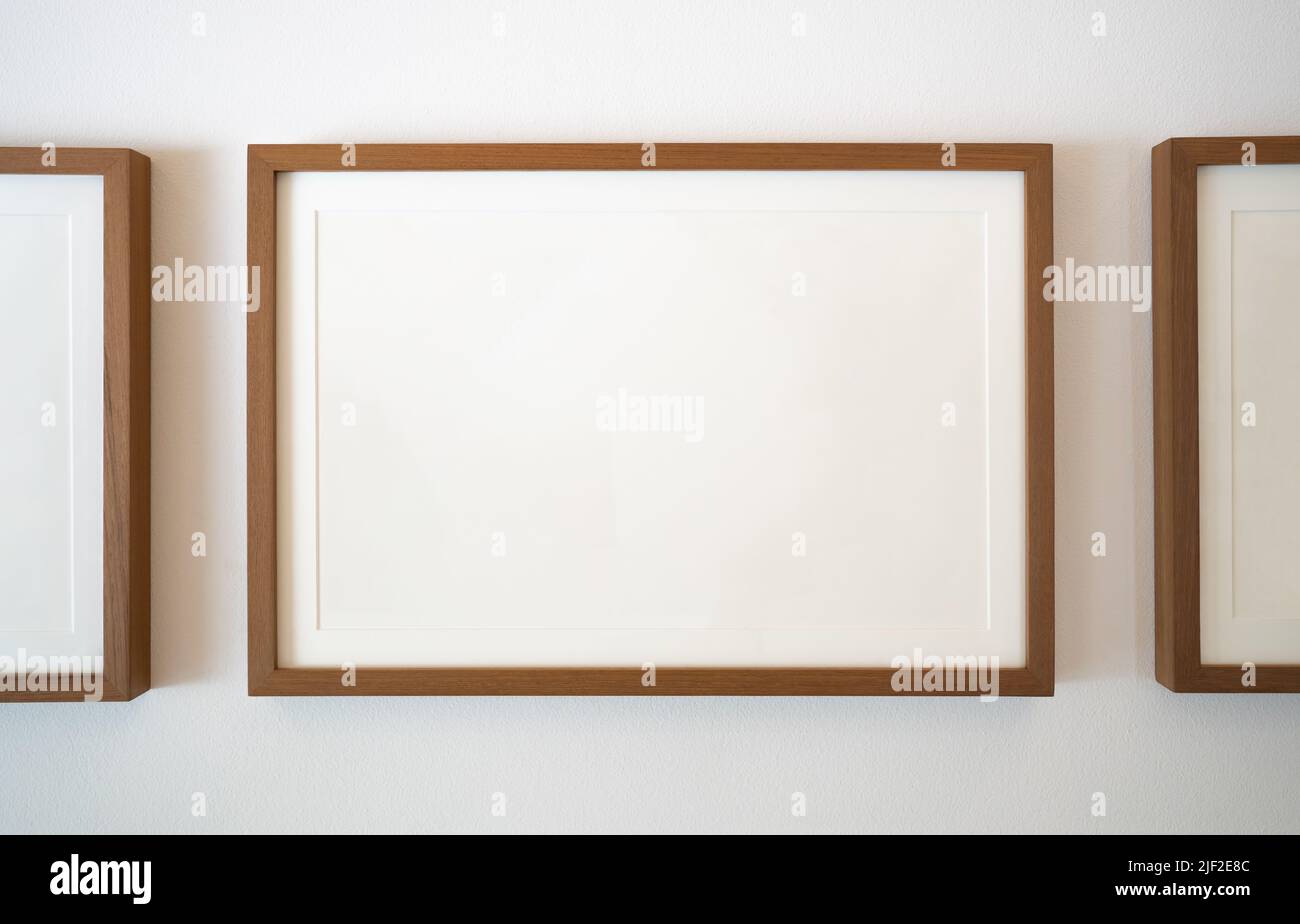 Wooden photo frames on white wall Stock Photo