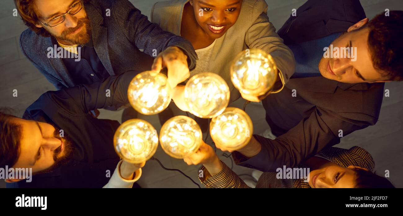 Creative business team with lightbulbs working together and developing creative ideas Stock Photo