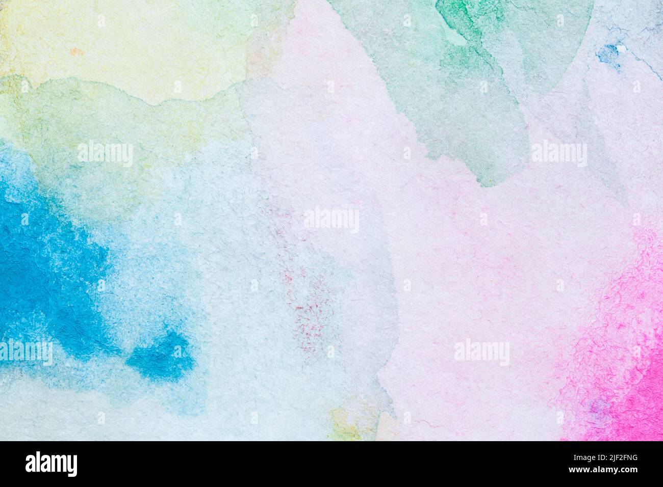 Macro close-up of an abstract colorful watercolor gradient fill background with watercolour stains. Full frame textured white paper background. Stock Photo