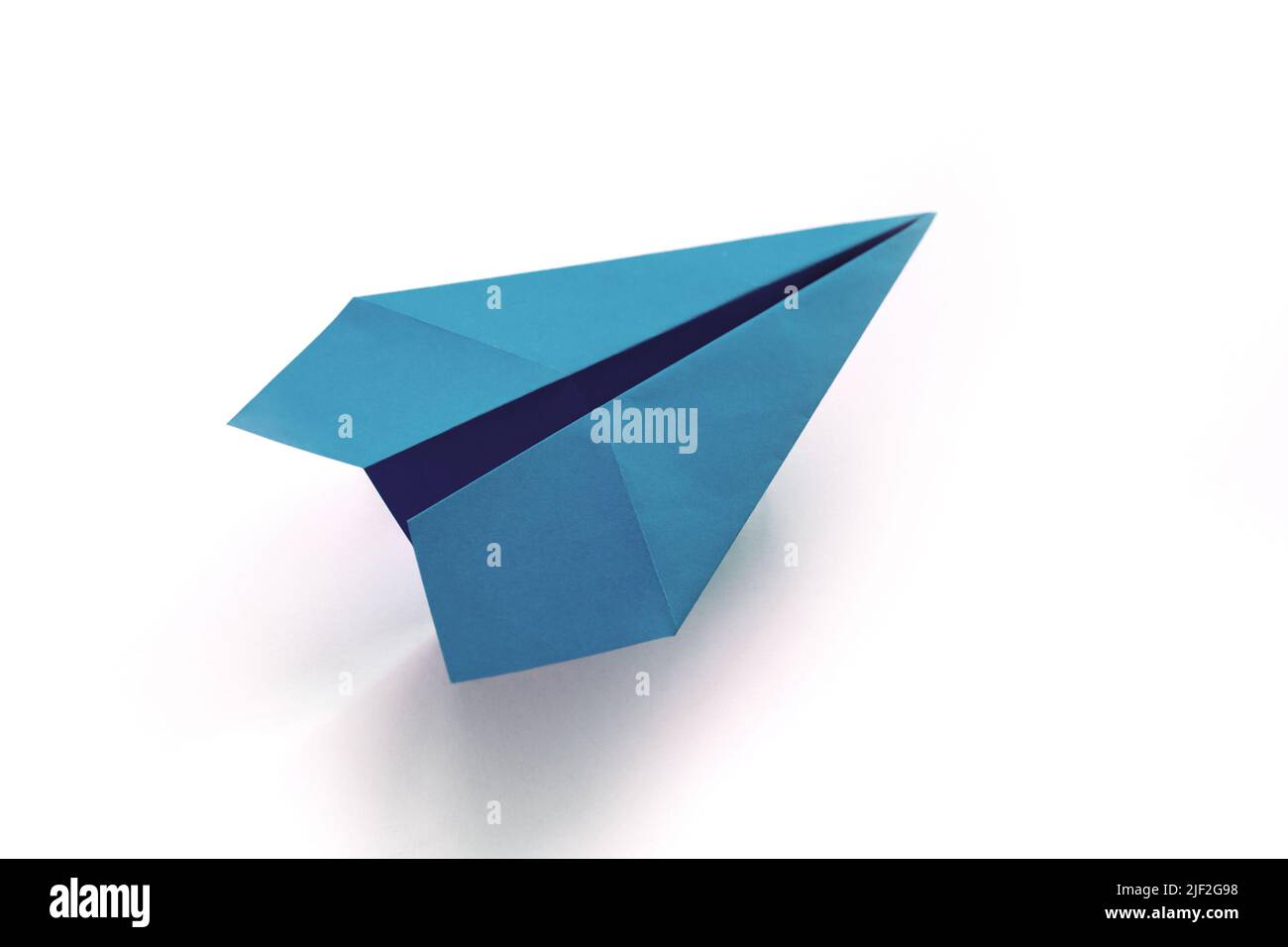 Blue paper plane origami isolated on a blank white background Stock Photo