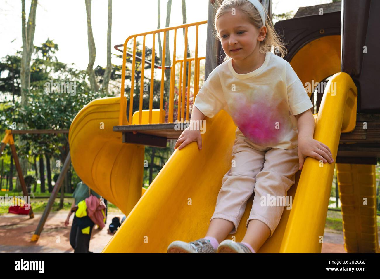 Active blonde little girl playing on a playground Stock Photo - Alamy