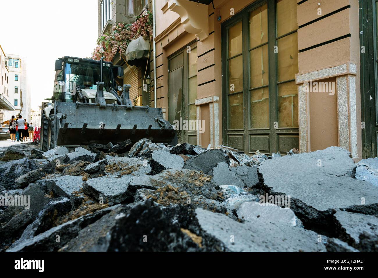 The tractor removing concrete debris and paving slabs Stock Photo Alamy