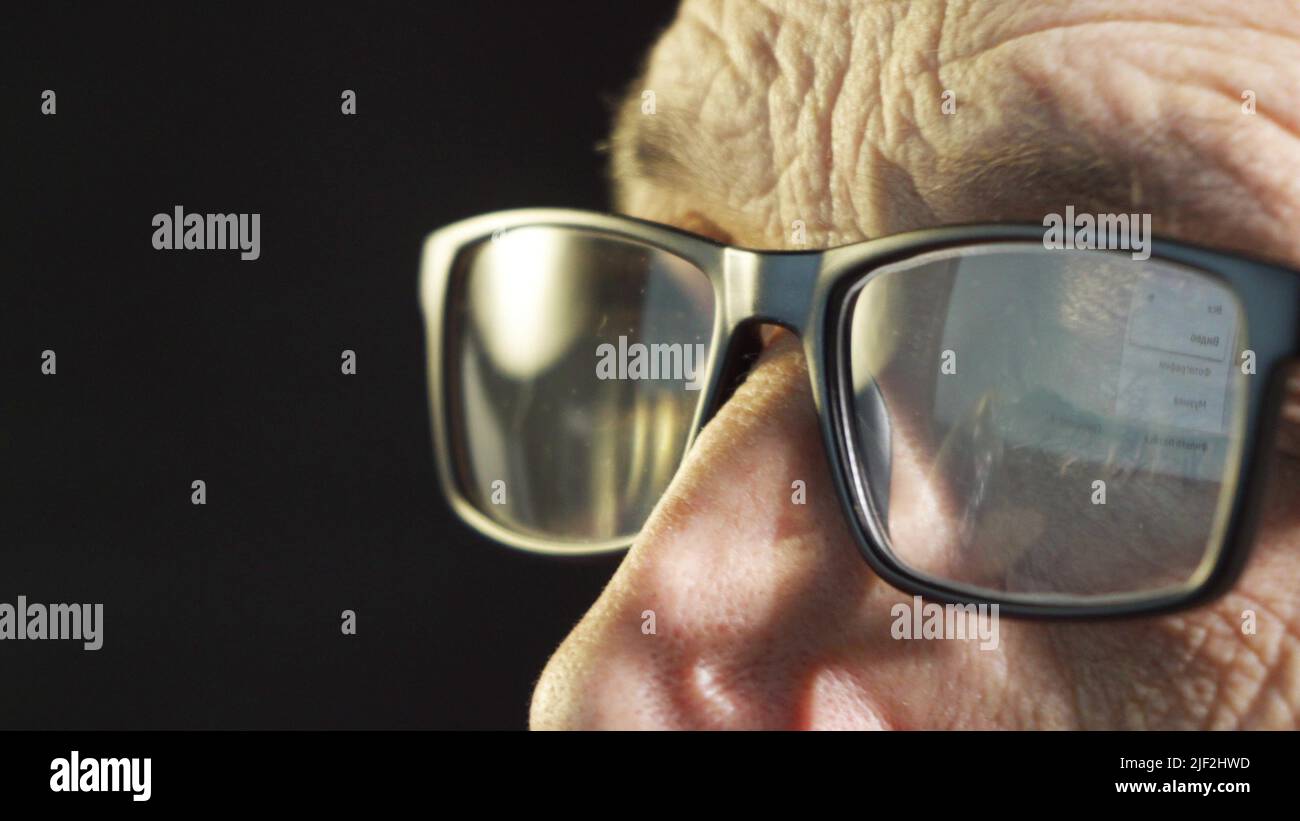 Eye fatigue. Closeup of closed eyes of a man wearing computer glasses