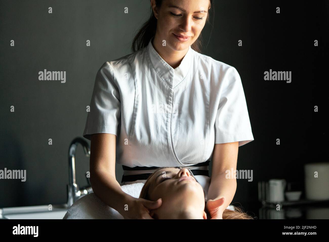 Healthy woman having massage therapy at spa salon Stock Photo