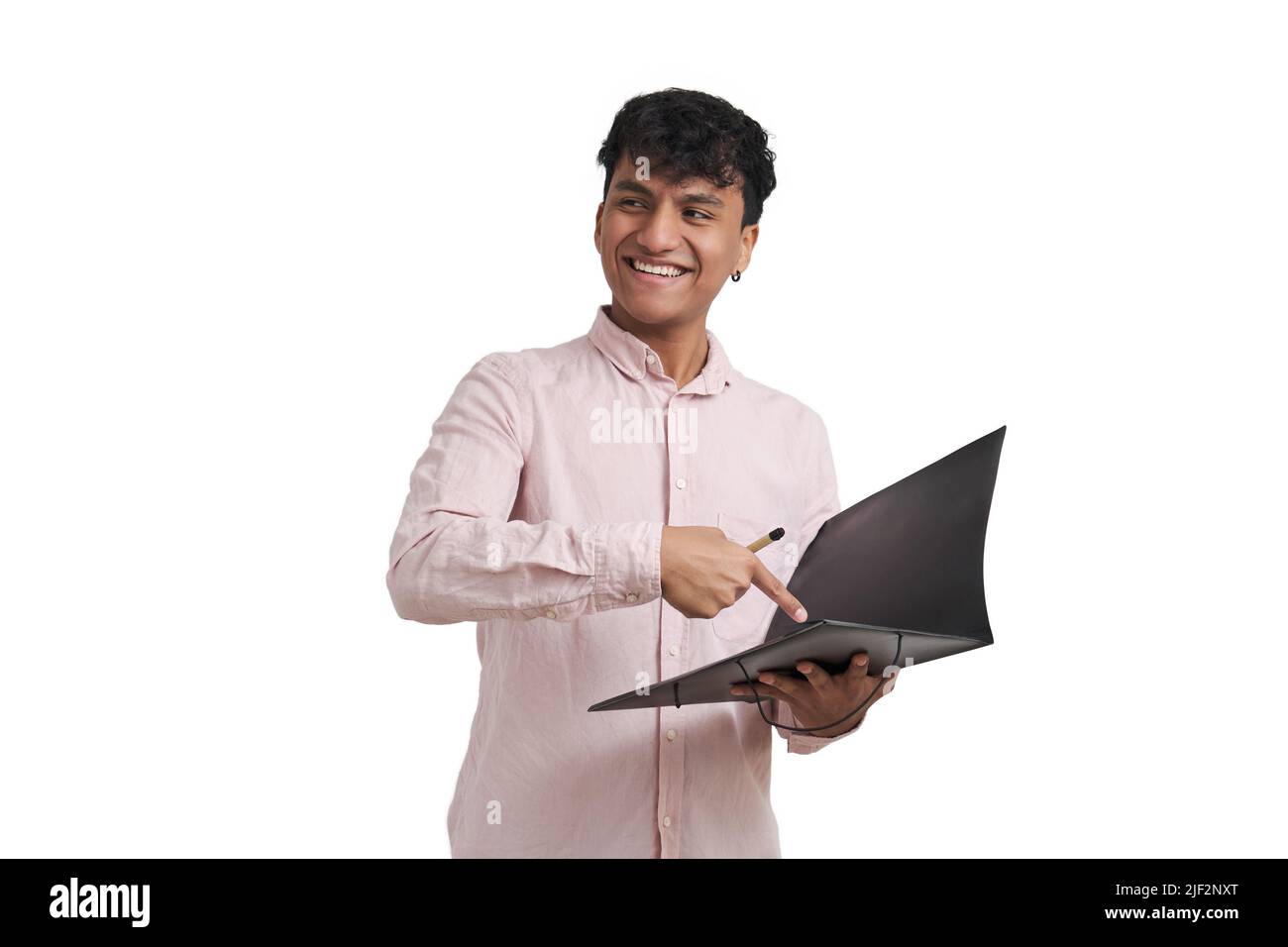 Young peruvian man smiling and pointing at a document in a folder, isolated. Stock Photo
