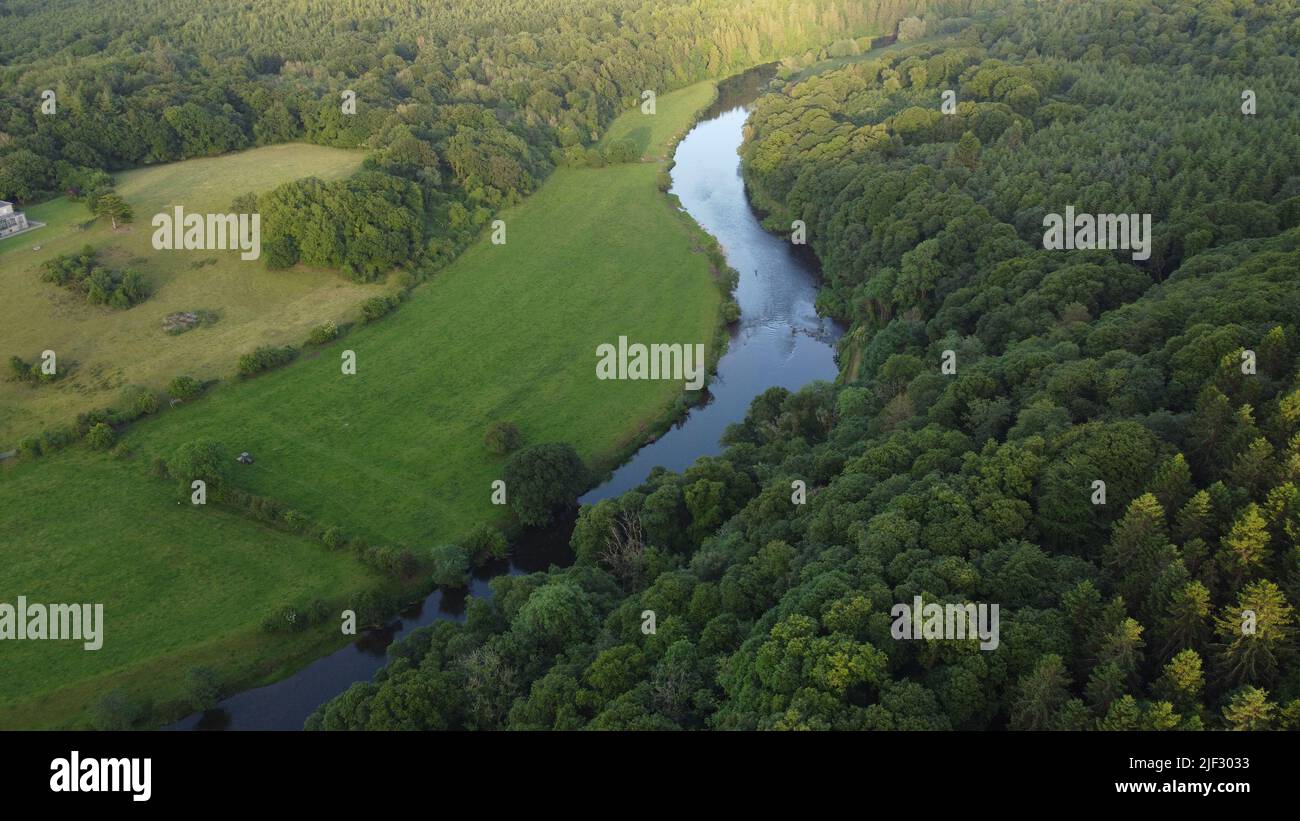 An aerial view of a river flowing through green land on a beautiful ...