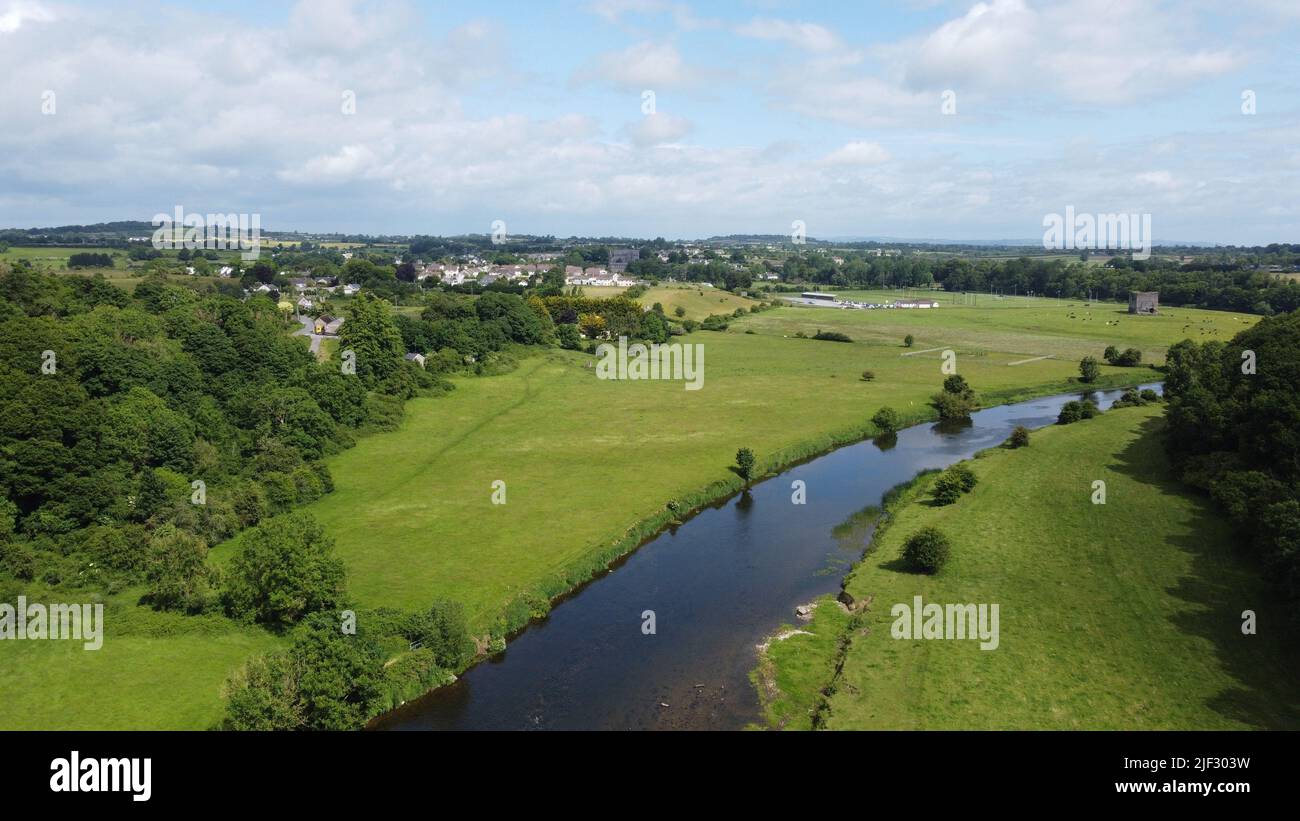 An aerial view of a river flowing through green land on a beautiful ...