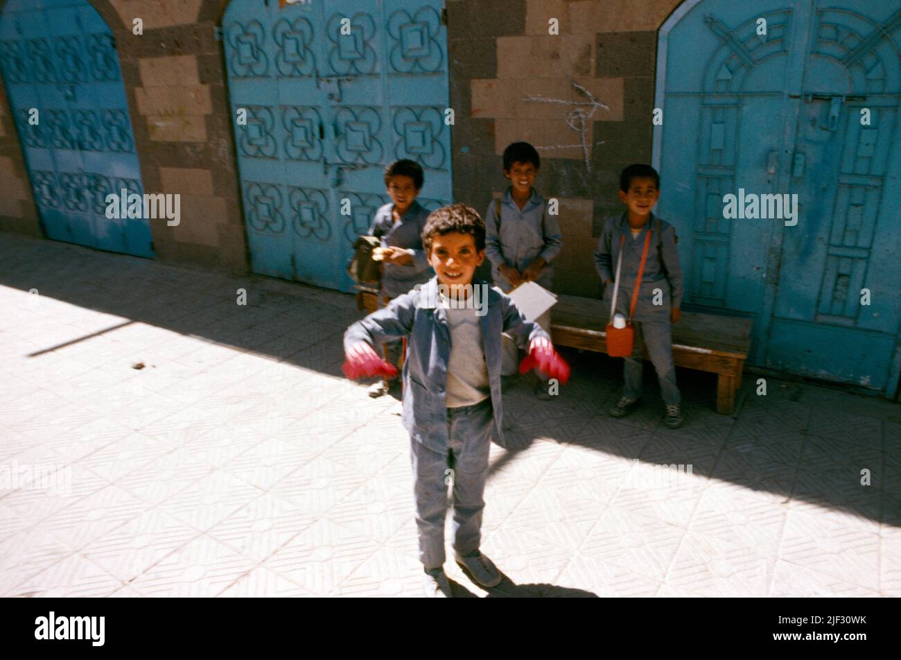 Sanaa Yemen Boy Wearing Gloves Standing In Front Of Friends In Street Stock Photo