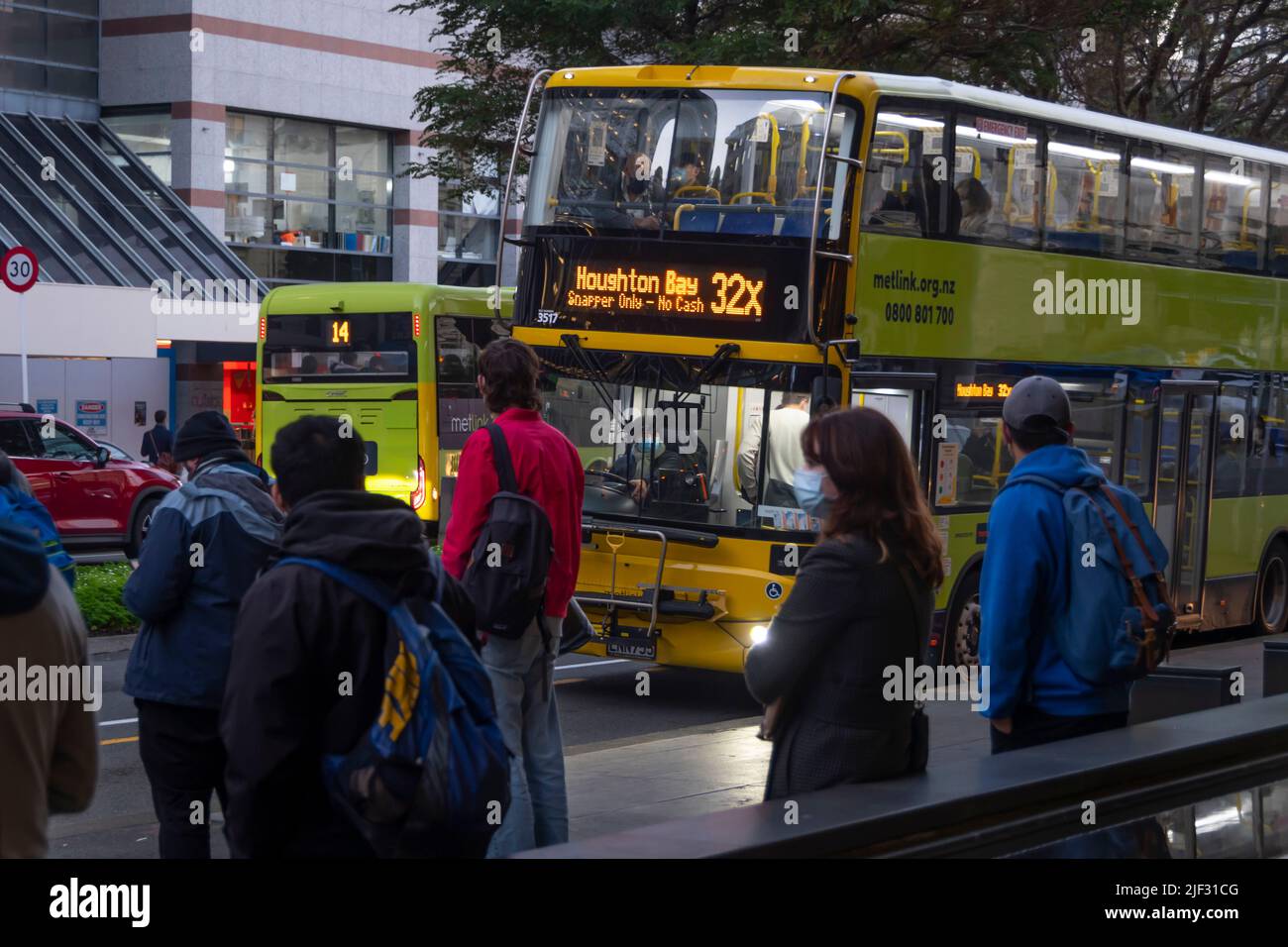 Commuters waiting at bus stop, Wellington, North Island, New Zealand Stock Photo