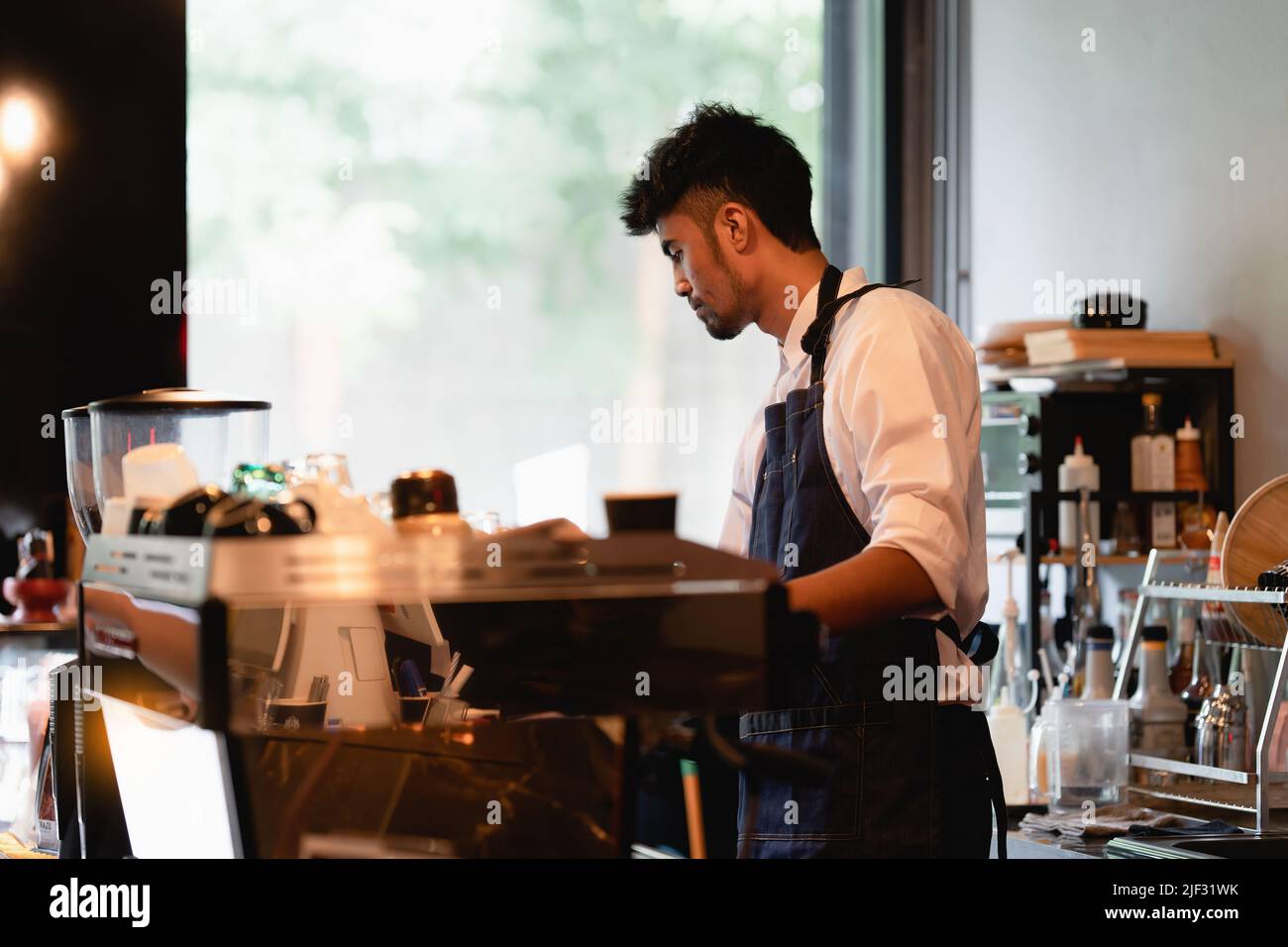 Asian Barista cafe owner while cafe open. SME entrepreneur seller