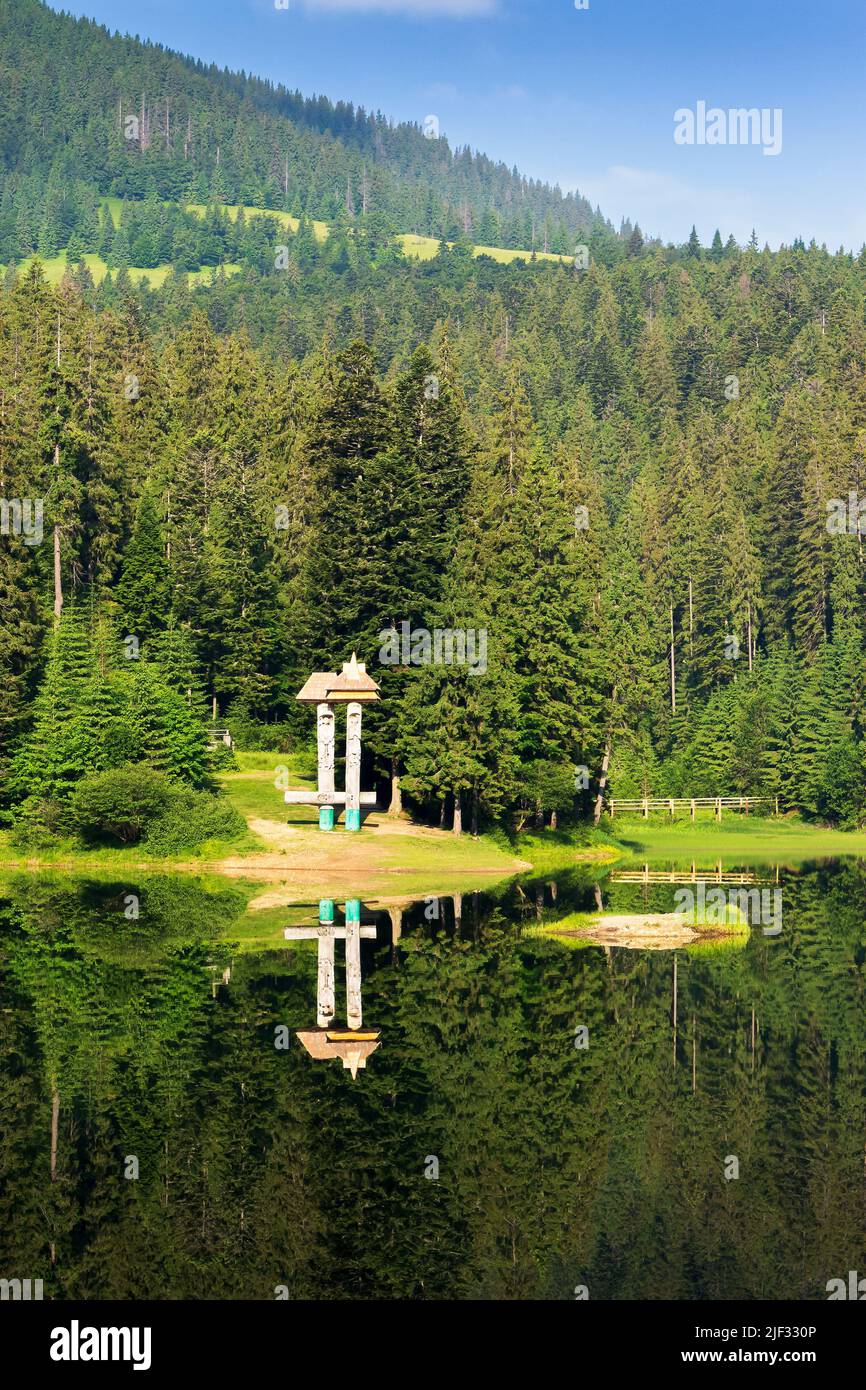 synevyr lake in summer. forest reflection in the water. beautiful travel background. green nature scene Stock Photo