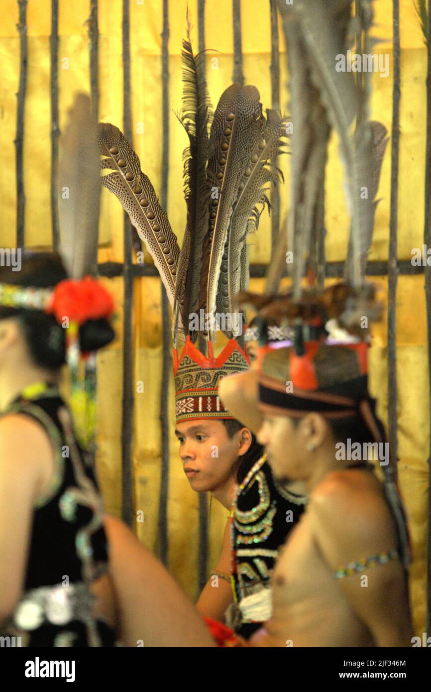 Portrait of men and women tourism workers wearing indigenous attires during an indigenous game show for tourists at Mari Mari Cultural Village, a village that is designed to showcase the cultures of five ethnic groups of Sabah—a Malaysian state in North Borneo, which is located on the outskirts of Kota Kinabalu in Sabah, Malaysia. Stock Photo