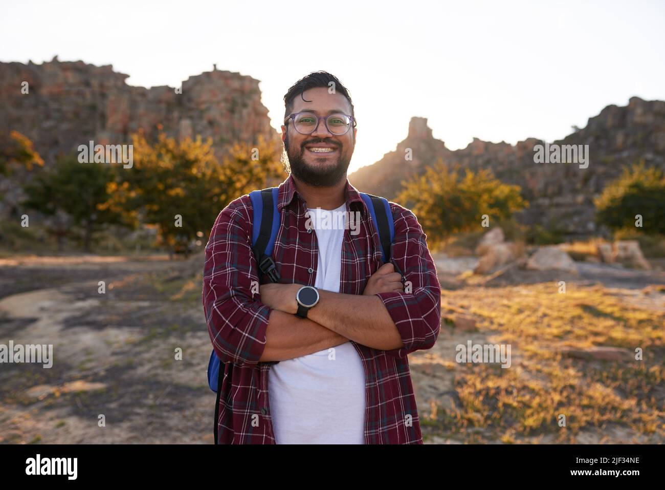 Young man hiking stands arms hi-res stock photography and images - Alamy
