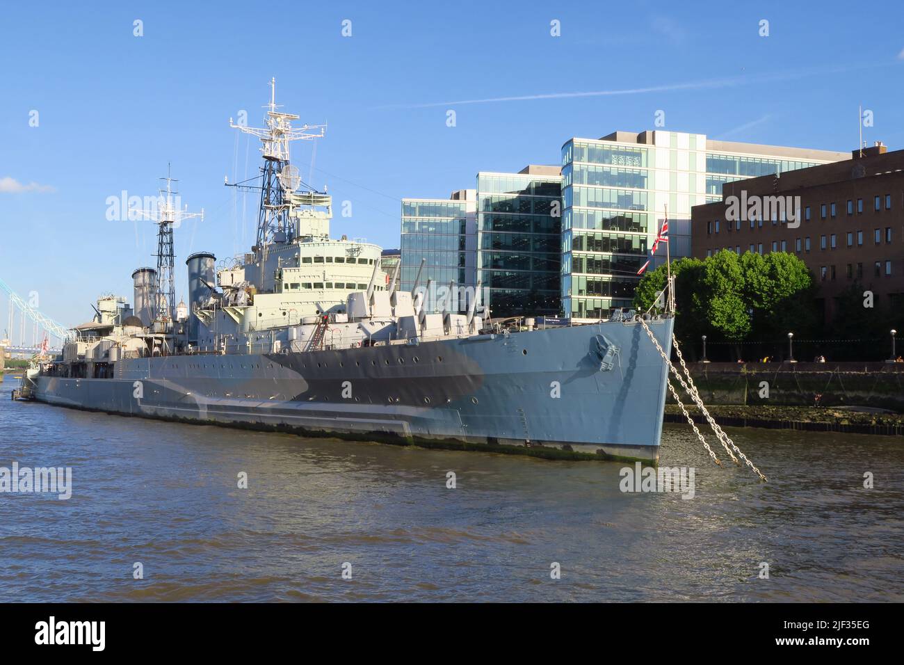 HMS Belfast, a WW2 cruiser, is moored on the south bank of the River Thames in London close to Tower Bridge. It serves as a living museum and tourist Stock Photo