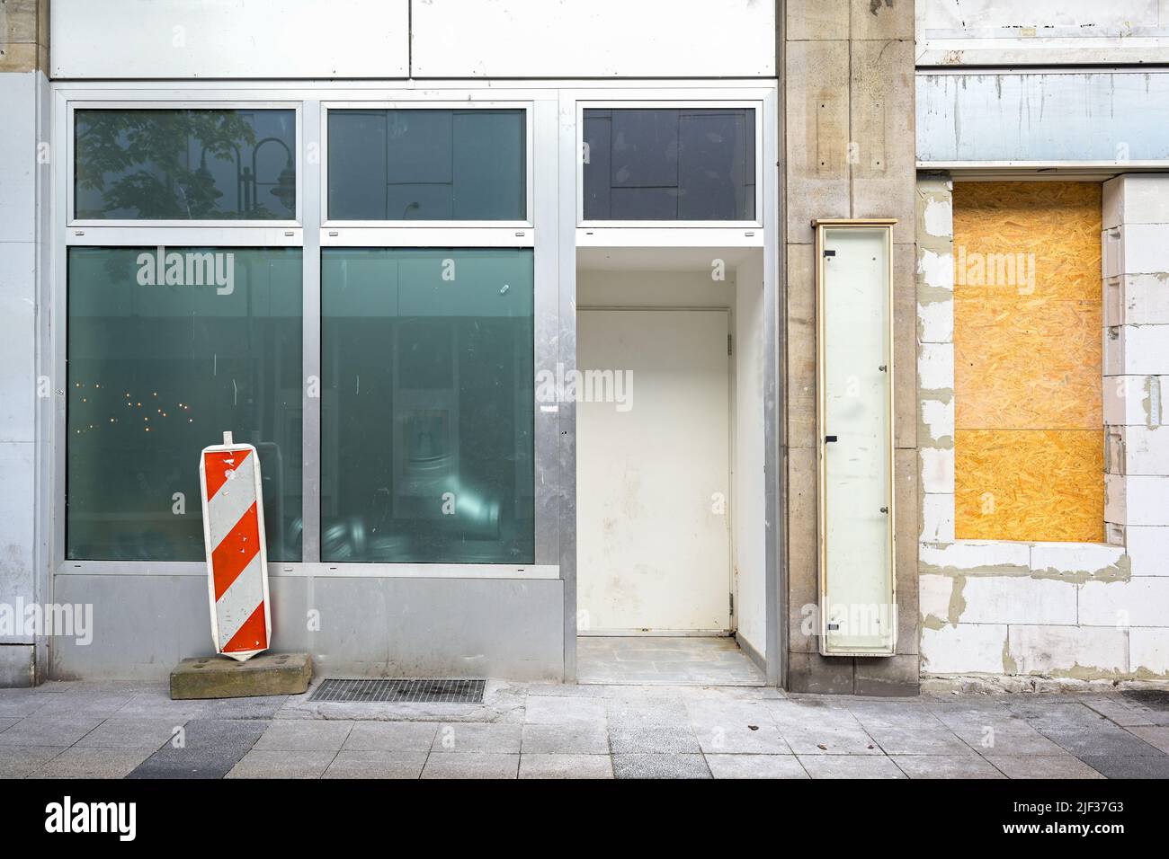 Abandoned city store after insolvency in the economic crisis due to coronavirus and inflation, renovation for a new start, copy space, selected focus Stock Photo