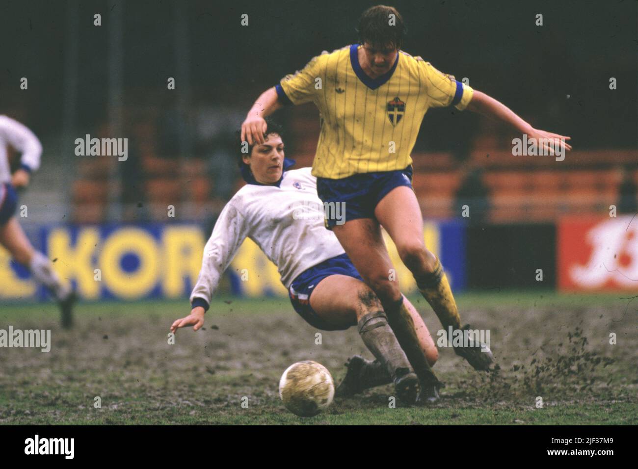 An England player tries a sliding tackle to win possession. Stock Photo