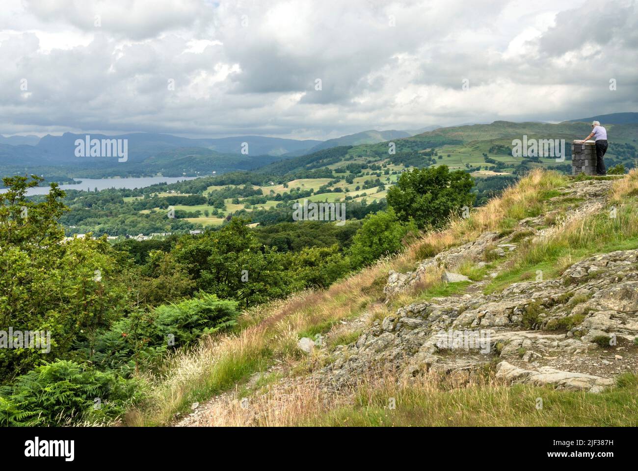 Walker looking out from the vantage point over Windermere, England's largest lake, United Kingdom, England, Cumbria, Lake District National Park Stock Photo