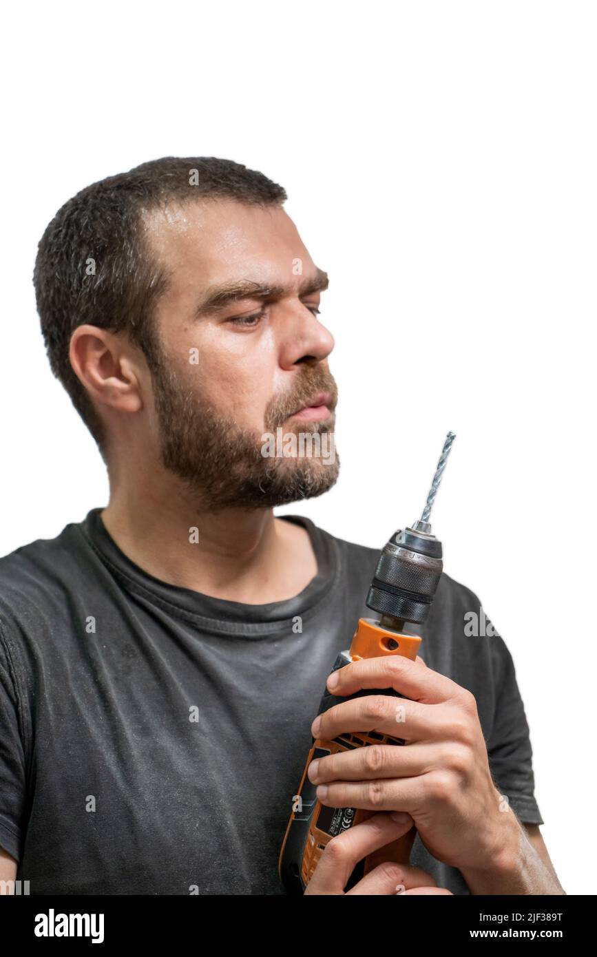 Selective focus shot of man posing with drill. Stock Photo